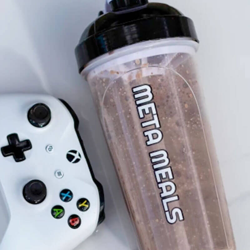 Meta Meals clear shaker bottle with chocolate meal replacement shake and XBox gaming controller